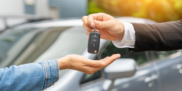 Happy customer receiving keys to their new car.